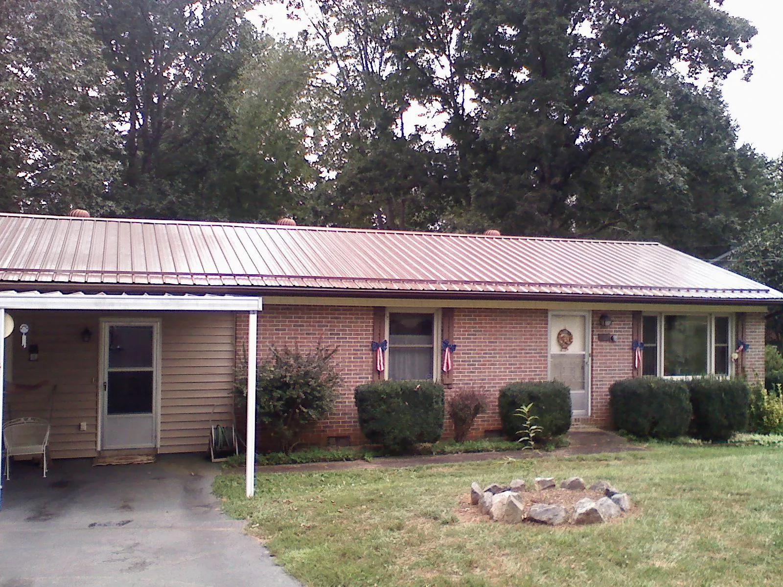 Bronze metal roof and carport on a brick ranch home — Roof Repair work by our crew in Heath Springs