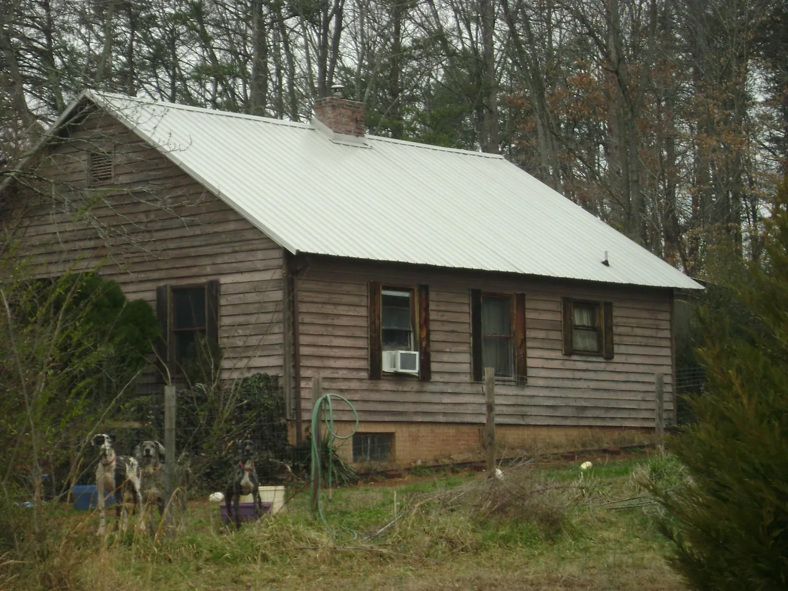 White metal roof on an old wood sided farmhouse, from a Metal Roof Installation job in Heath Springs